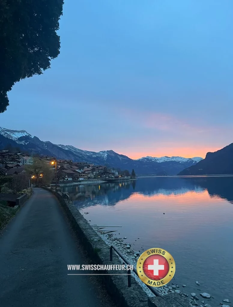 Luxury chauffeur-driven car in the Swiss Alps during sunset – premium private transfer service with panoramic views