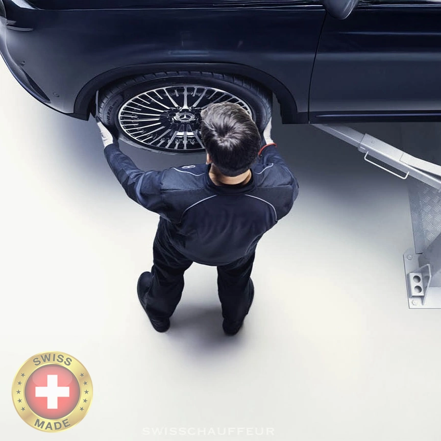 Swiss luxury chauffeur service technician maintaining Mercedes-Benz vehicle in Switzerland