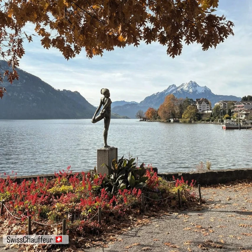 Off season travel in Switzerland view of Weggis, Lake Lucerne, mountains and lakeside statue