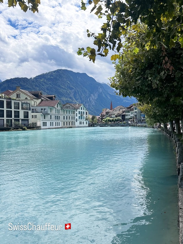 Interlaken chauffeur service with Alpine views beside the turquoise water in Switzerland