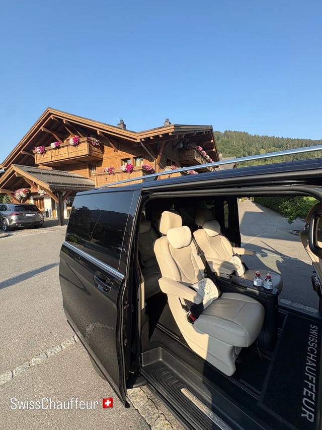 Mercedes-Benz V-Class Exclusive with elegant beige leather seating outside a traditional Swiss chalet, prepared for private chauffeur travel in Switzerland.
