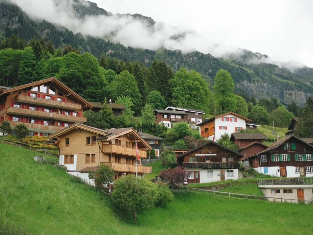 Traditional Swiss chalets and misty mountains during a private chauffeur in Lungern journey.
